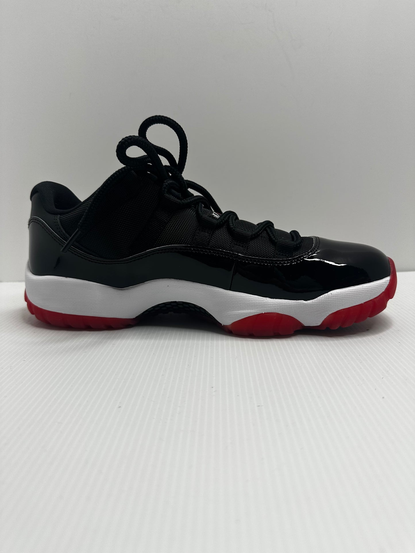 Jordan 11 Retro Low Bred (2025) - Black/Red/White